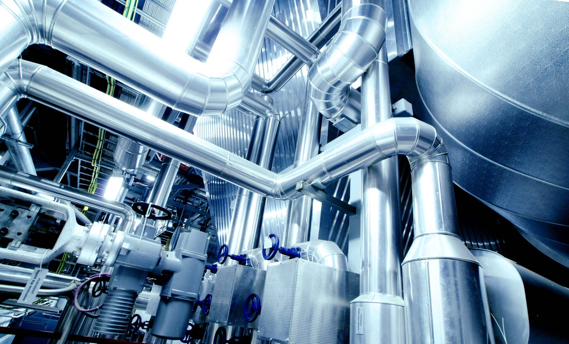 Equipment, cables and piping as found inside of a modern industrial power plant.